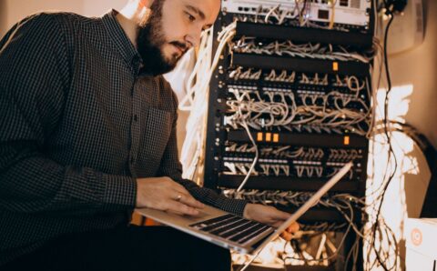 Young it service man repairing computer