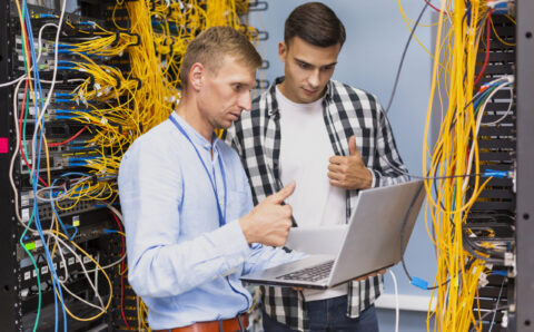 young-network-engineers-with-laptop-medium-shot